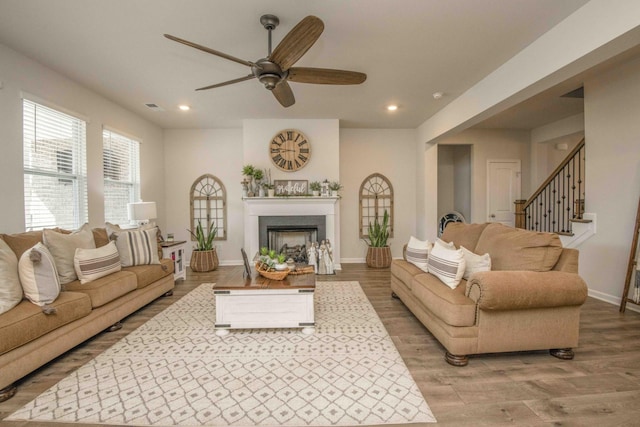 living area with wood finished floors, a ceiling fan, and recessed lighting