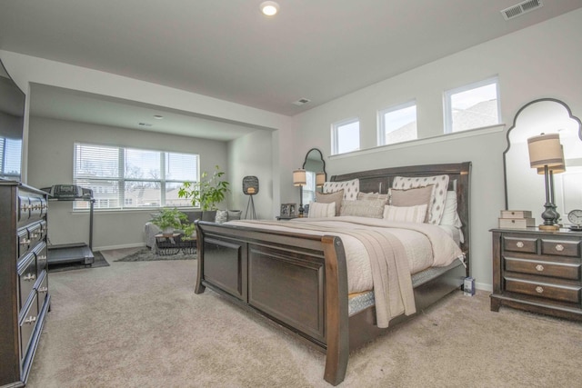 bedroom featuring light colored carpet, baseboards, and visible vents
