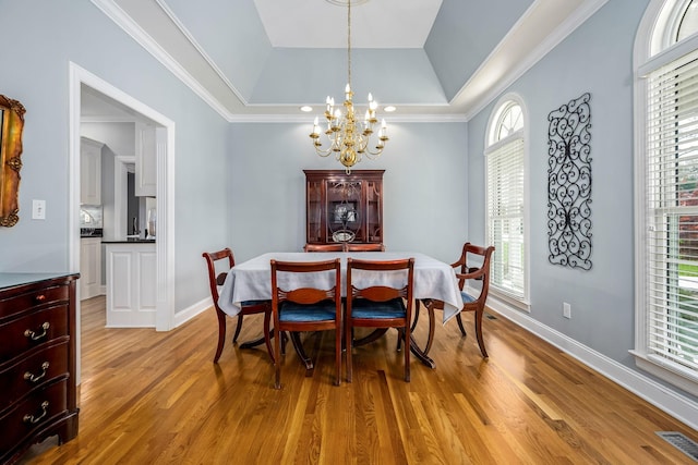 dining area featuring visible vents, a wealth of natural light, light wood finished floors, and a notable chandelier