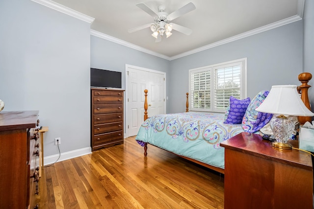 bedroom featuring crown molding, wood finished floors, ceiling fan, and baseboards