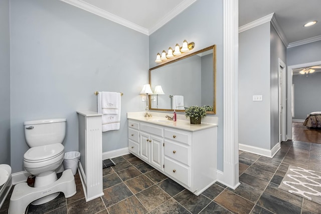 full bath featuring stone tile floors, baseboards, ornamental molding, and toilet