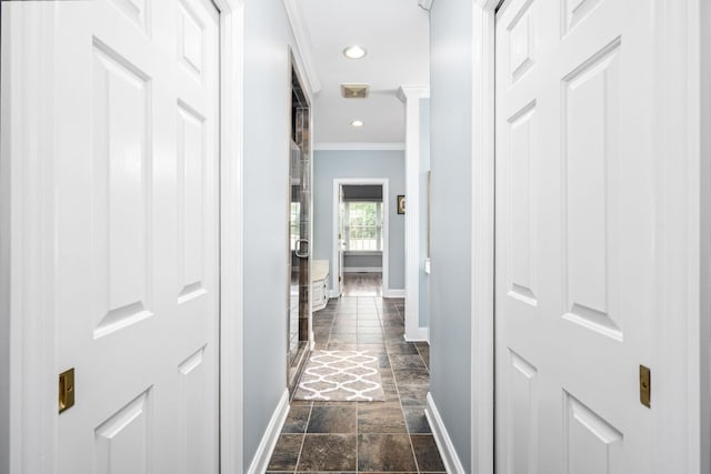 corridor featuring baseboards, ornamental molding, recessed lighting, stone tile flooring, and visible vents