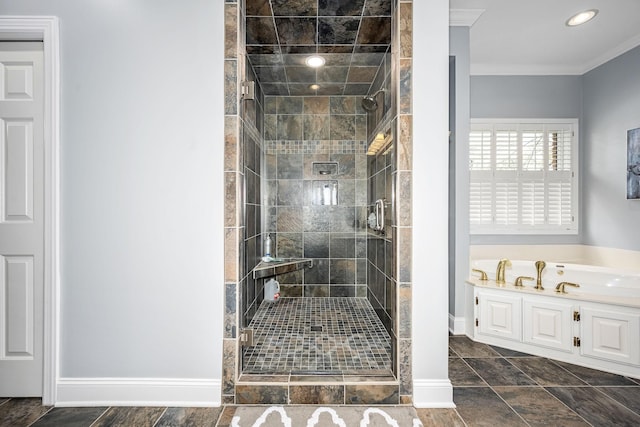 full bath featuring a shower stall, crown molding, a garden tub, and baseboards