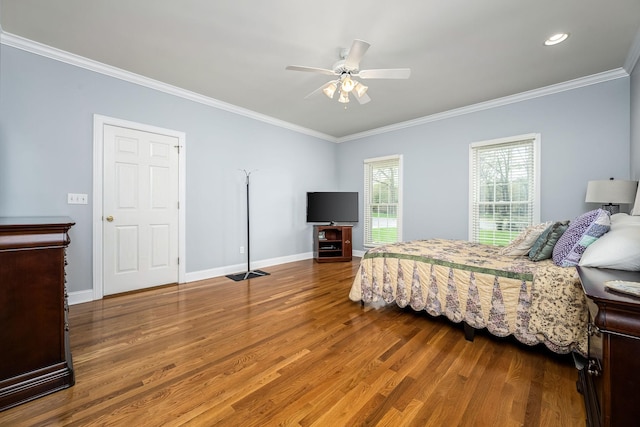 bedroom featuring ceiling fan, baseboards, ornamental molding, and wood finished floors