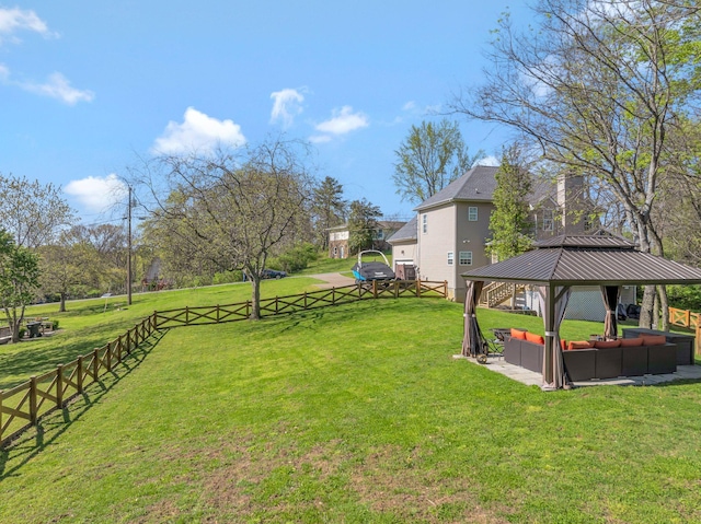 view of yard with an outdoor living space, fence, and a gazebo