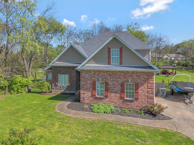 craftsman-style home featuring a front yard, brick siding, and a shingled roof