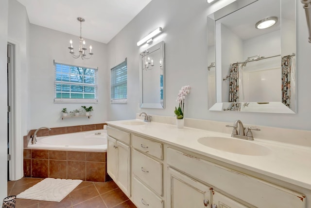bathroom featuring a bath, tile patterned floors, an inviting chandelier, and a sink