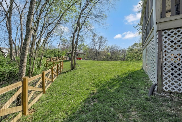 view of yard with fence and an outdoor structure