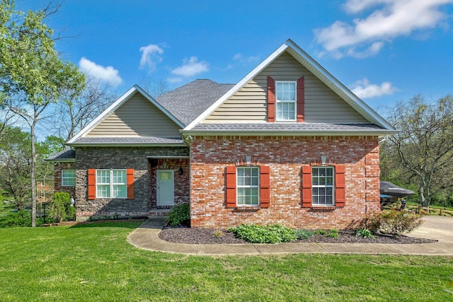 craftsman inspired home featuring brick siding, a shingled roof, and a front lawn