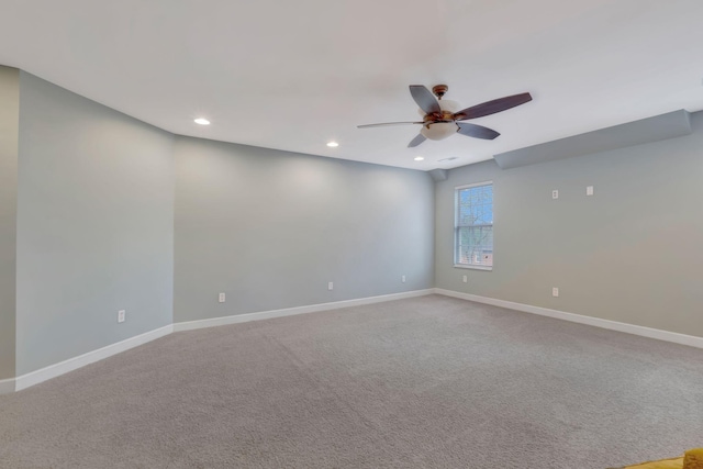 carpeted spare room featuring ceiling fan, baseboards, and recessed lighting