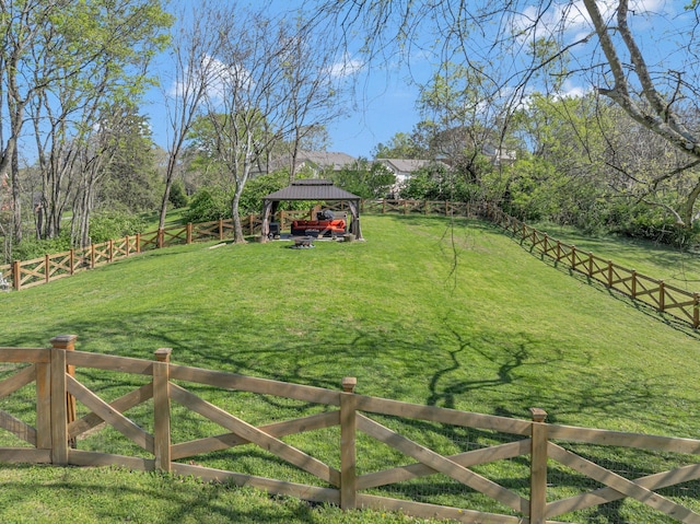 view of yard featuring a gazebo and a fenced backyard