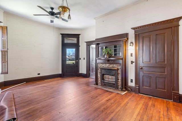 201 Knob Creek Rd, Wartrace, TN 37183 - unfurnished living room with hardwood / wood-style floors, baseboards, ornamental molding, a fireplace, and a ceiling fan