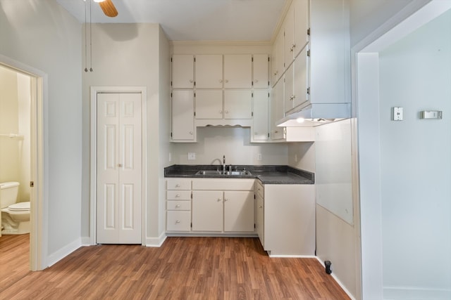 201 Knob Creek Rd, Wartrace, TN 37183 - kitchen with dark countertops, light wood-type flooring, baseboards, and a sink