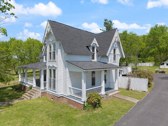 201 Knob Creek Rd, Wartrace, TN 37183 - view of home's exterior with a lawn, roof with shingles, covered porch, and fence