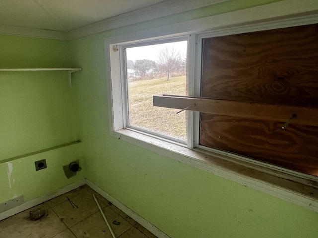 laundry area with hookup for an electric dryer, baseboards, tile patterned floors, crown molding, and laundry area