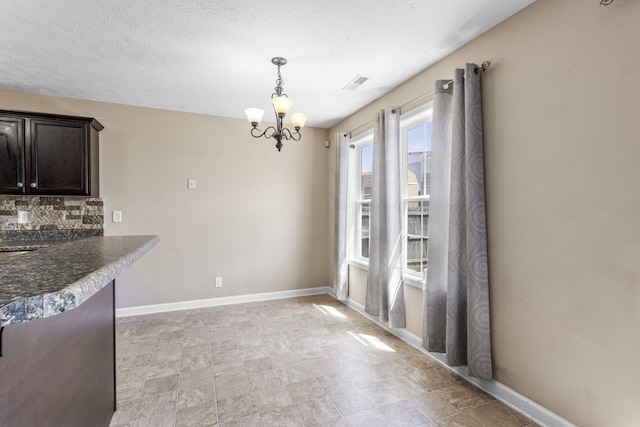 1995 General Neyland Dr, Clarksville, TN 37042 - unfurnished dining area featuring a notable chandelier, visible vents, and baseboards