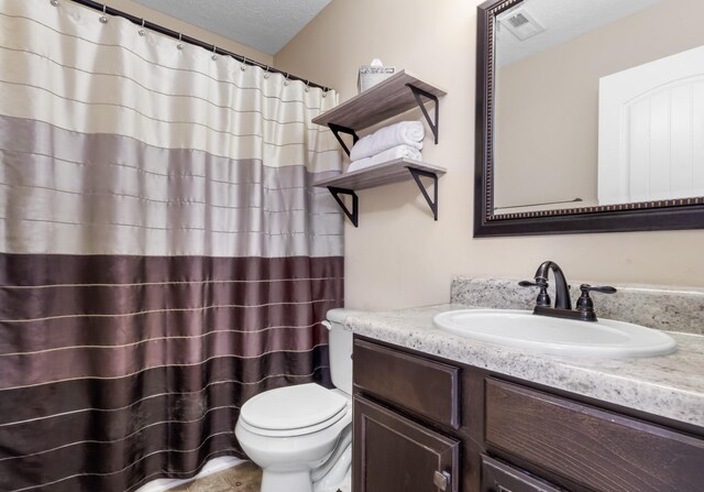 1995 General Neyland Dr, Clarksville, TN 37042 - full bathroom with a shower with shower curtain, vanity, a textured ceiling, toilet, and visible vents