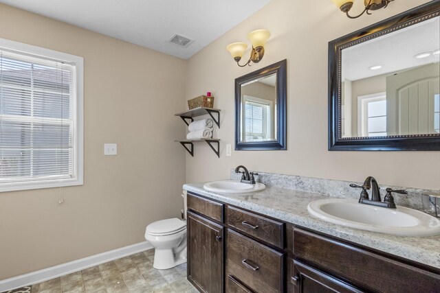 1995 General Neyland Dr, Clarksville, TN 37042 - full bathroom featuring a sink, visible vents, baseboards, and toilet