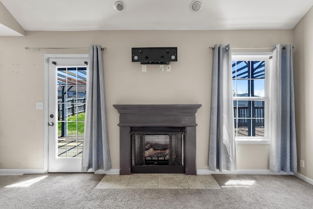 1995 General Neyland Dr, Clarksville, TN 37042 - unfurnished living room featuring carpet floors, a wealth of natural light, and a fireplace with flush hearth