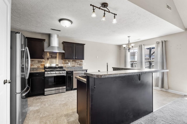 1995 General Neyland Dr, Clarksville, TN 37042 - kitchen featuring tasteful backsplash, a center island, visible vents, wall chimney exhaust hood, and stainless steel appliances
