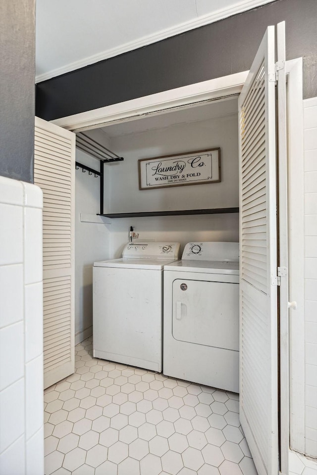 laundry room featuring light floors, separate washer and dryer, and laundry area