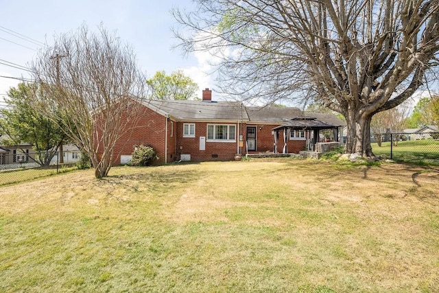 view of front of house featuring a front yard, fence, a gazebo, brick siding, and a chimney