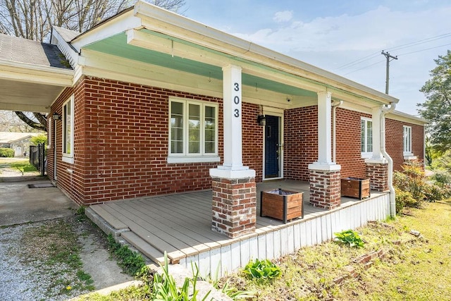 exterior space with brick siding and a porch