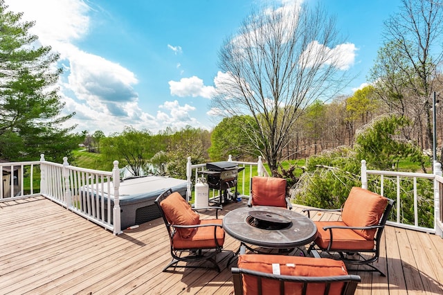 wooden deck with an outdoor fire pit and area for grilling