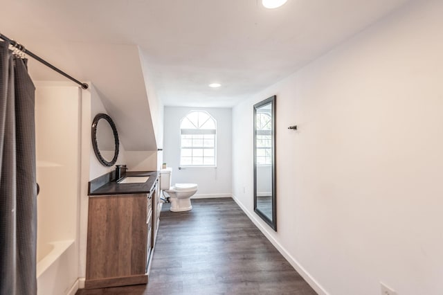 full bathroom featuring vanity, toilet, shower / bath combination, wood finished floors, and baseboards