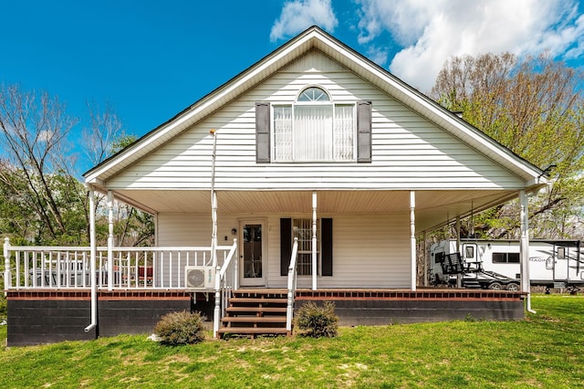 farmhouse-style home with covered porch and a front yard