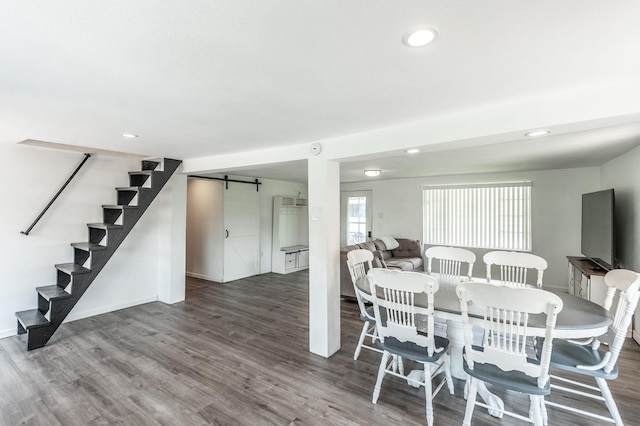 dining area featuring recessed lighting, stairway, a barn door, and wood finished floors