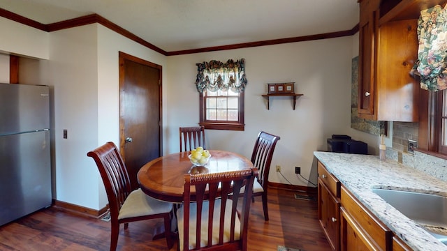 2519 Old Greenbrier Pike, Greenbrier, TN 37073 - dining space with dark wood-style flooring, baseboards, and crown molding
