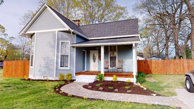 2519 Old Greenbrier Pike, Greenbrier, TN 37073 - view of front of home featuring a shingled roof, a porch, crawl space, fence, and a front lawn