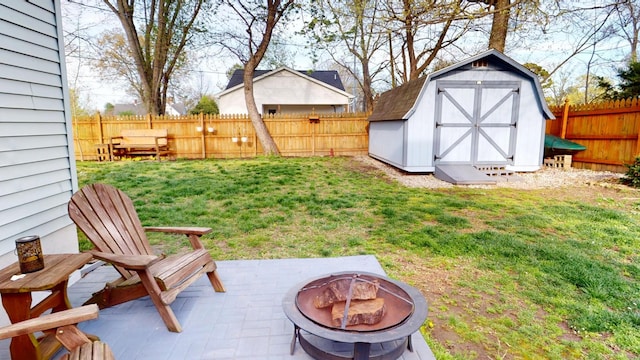 2519 Old Greenbrier Pike, Greenbrier, TN 37073 - view of yard with an outdoor fire pit, a fenced backyard, an outdoor structure, a patio, and a storage unit