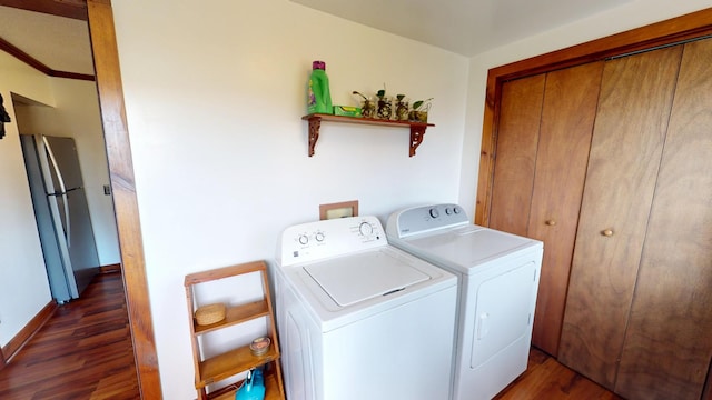 2519 Old Greenbrier Pike, Greenbrier, TN 37073 - laundry room featuring independent washer and dryer, laundry area, wood finished floors, and baseboards