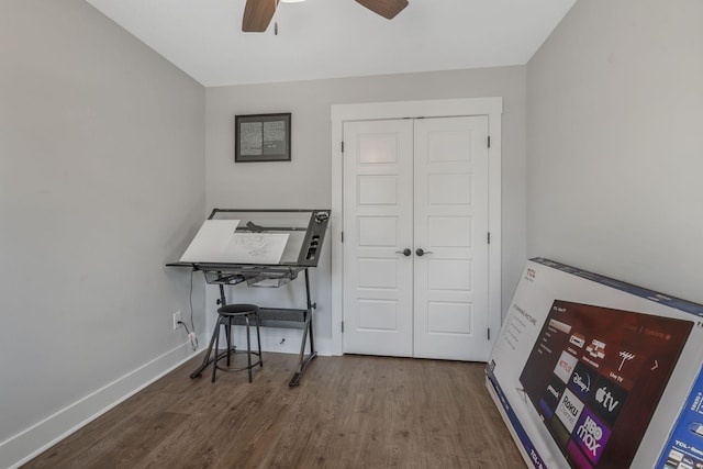 home office with ceiling fan, wood finished floors, and baseboards