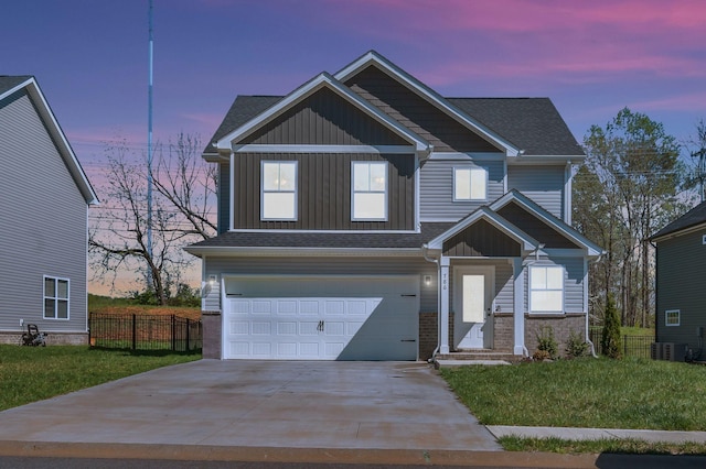 view of front facade with board and batten siding, a front yard, fence, an attached garage, and concrete driveway