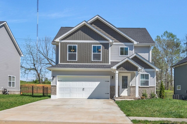 craftsman house featuring a front yard, a garage, board and batten siding, fence, and driveway
