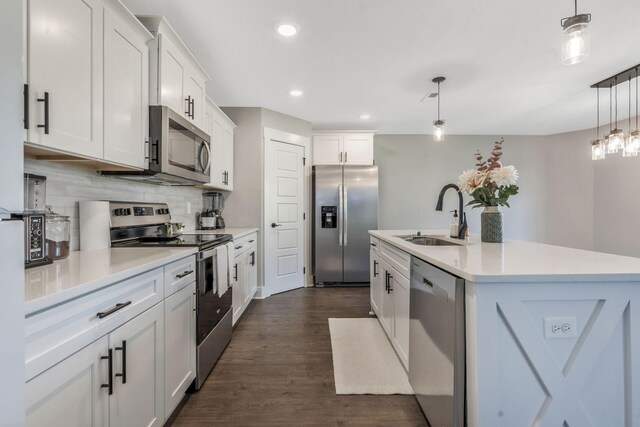 kitchen featuring decorative backsplash, light countertops, a sink, and appliances with stainless steel finishes