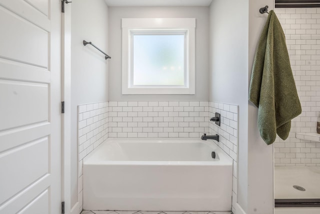 full bath featuring a bath and a shower stall