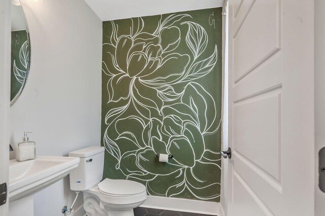 bathroom with toilet and tile patterned flooring