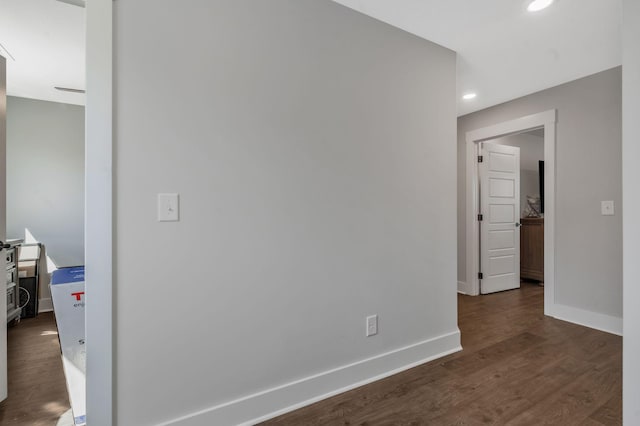 interior space featuring baseboards, recessed lighting, and dark wood finished floors