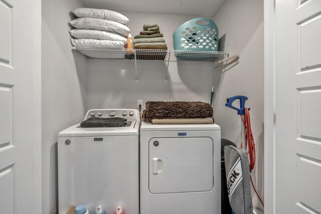clothes washing area featuring washer and clothes dryer
