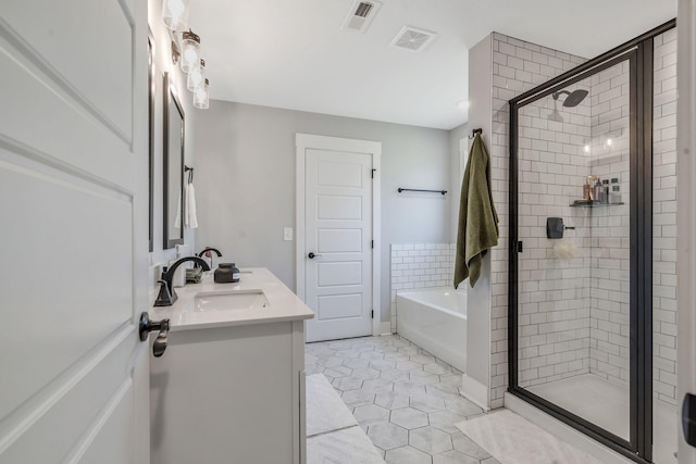 full bathroom with a bath, a stall shower, a sink, and visible vents