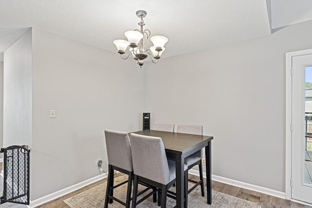 238 Kathleen Ct, Clarksville, TN 37043 - dining room featuring baseboards, wood finished floors, a notable chandelier, and visible vents