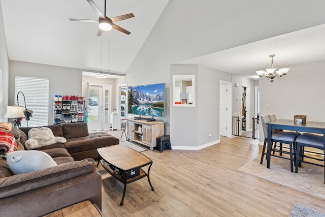 238 Kathleen Ct, Clarksville, TN 37043 - living area featuring high vaulted ceiling, light wood-style flooring, ceiling fan with notable chandelier, and baseboards