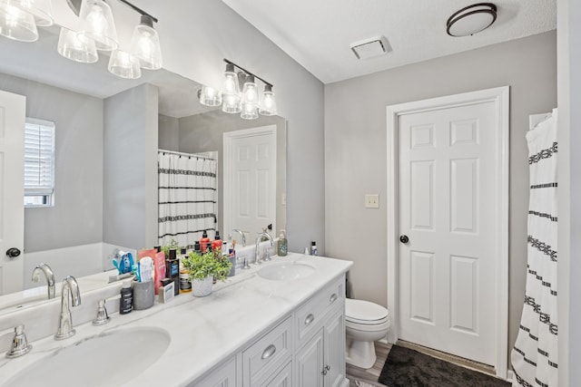 238 Kathleen Ct, Clarksville, TN 37043 - bathroom with a sink, visible vents, toilet, and double vanity