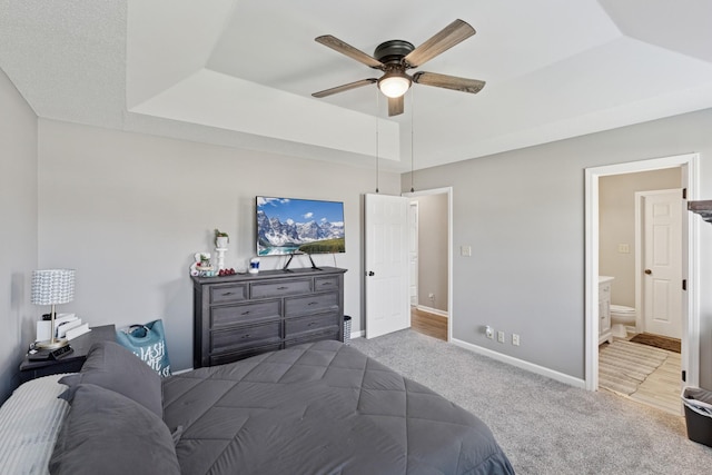 238 Kathleen Ct, Clarksville, TN 37043 - carpeted bedroom featuring a tray ceiling, ensuite bathroom, baseboards, and a ceiling fan