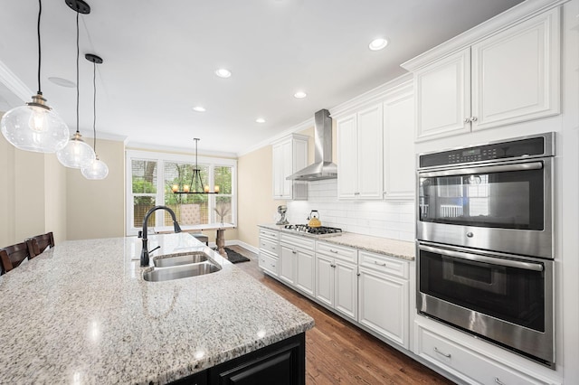 15 Westlawn Ct, Nashville, TN 37209 - kitchen featuring wall chimney exhaust hood, a sink, ornamental molding, appliances with stainless steel finishes, and light stone counters