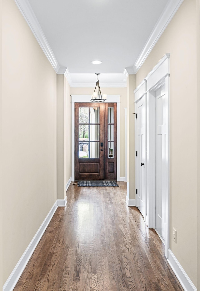 15 Westlawn Ct, Nashville, TN 37209 - entrance foyer featuring crown molding, baseboards, a notable chandelier, and dark wood-type flooring